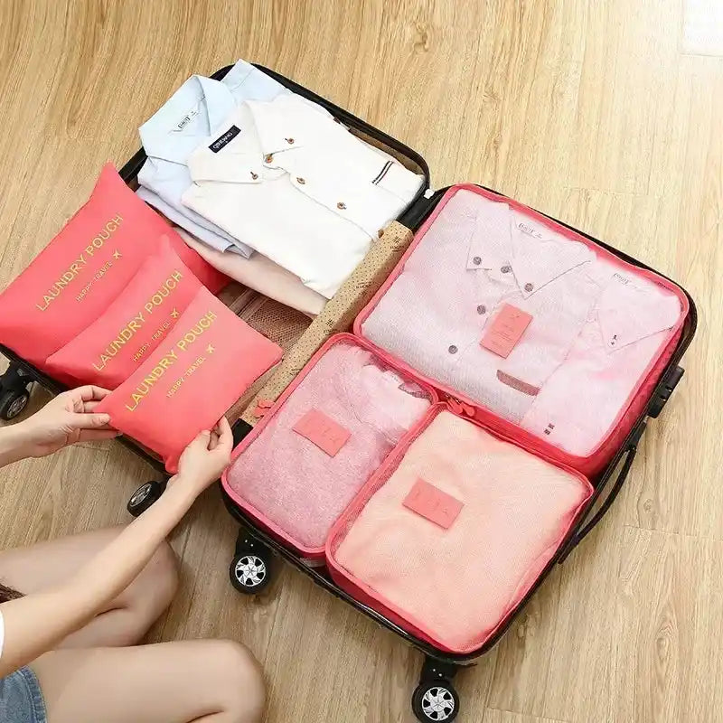 Pink 6PC Travel Storage Set organizing shirts and garments in a suitcase, ideal for neat and compact travel packing.