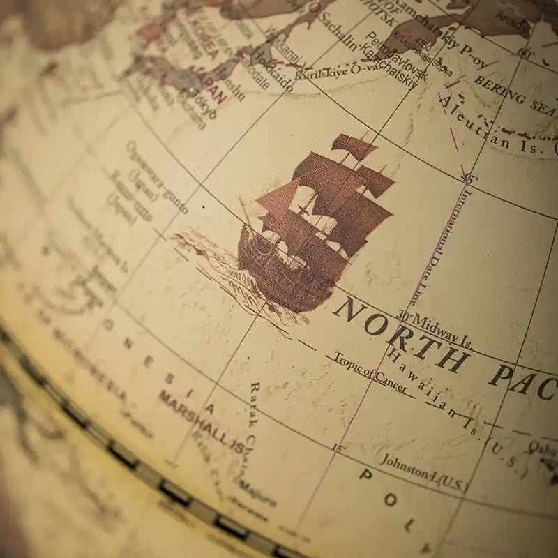 Close-up of a vintage map with a ship illustration on 'North Pacific' label