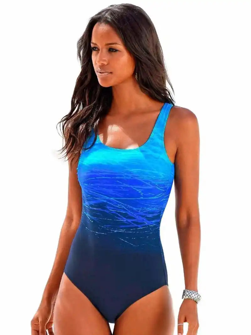 Blue gradient sporty one-piece swimsuit for women. Offers active fit and support, perfect for swimming or beachwear in plus sizes.