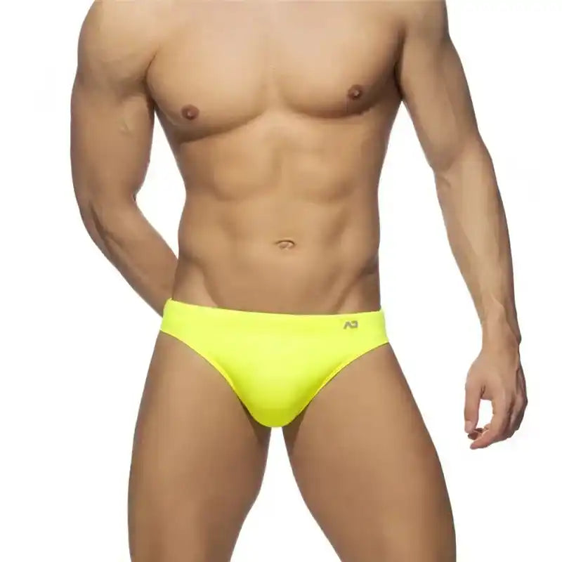 Men's bright yellow swim briefs with push-up pouch and sunga cut, offering a bold and supportive fit for beach or pool.