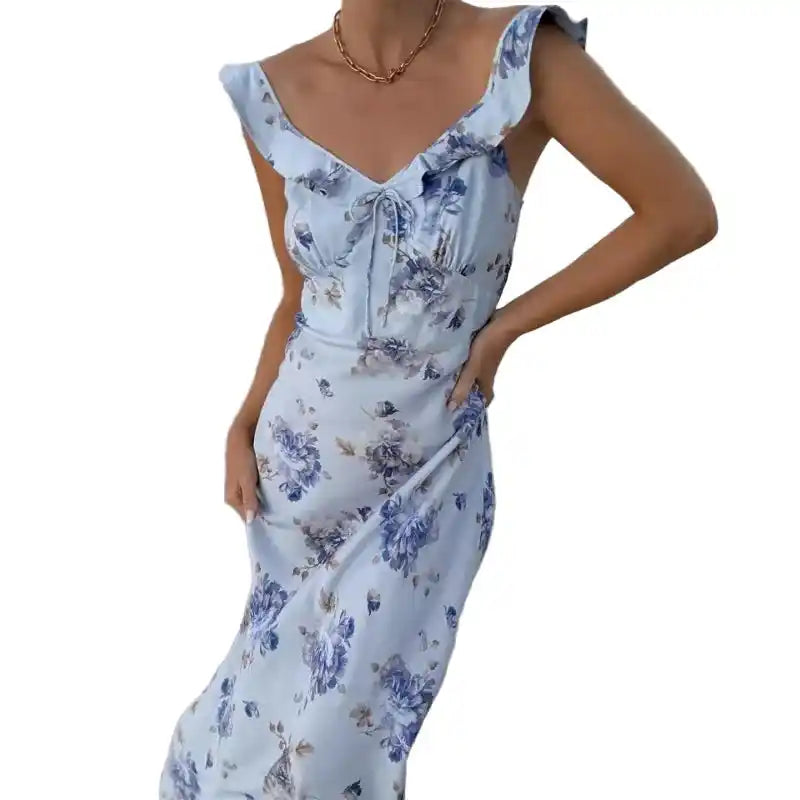Blue floral Cryptographic plunge maxi dress with ruffle sleeves, styled for beachwear or summer vacation fashion.