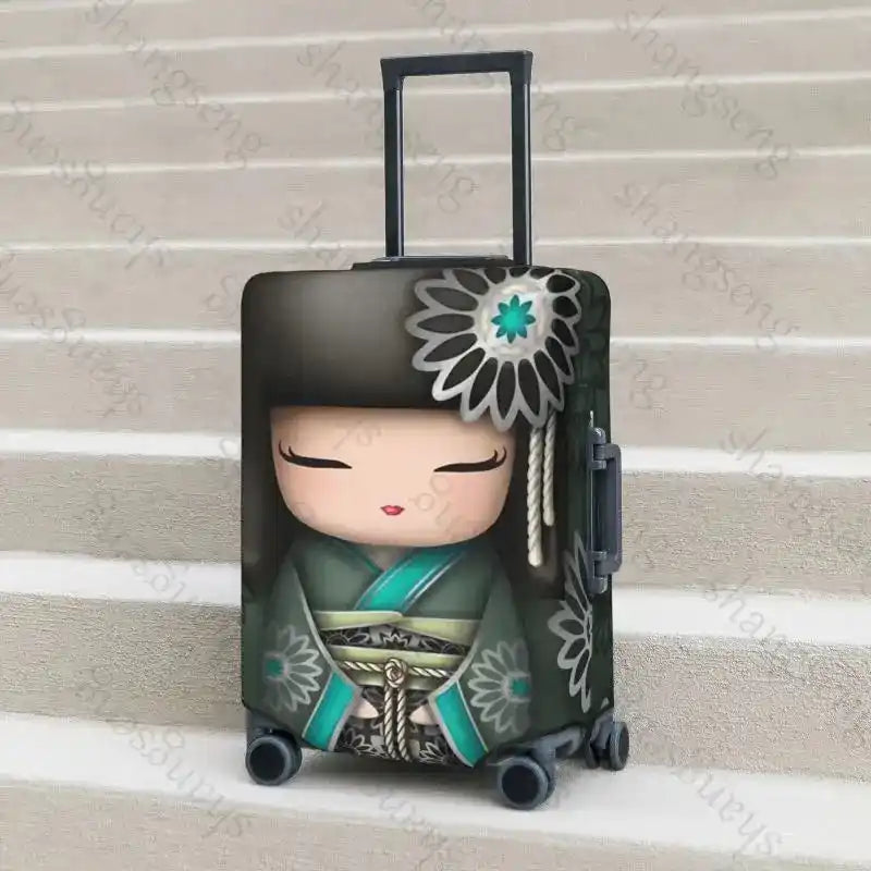 Green and black Japanese Kokeshi Doll Luggage Cover with teal kimono design on suitcase. Elastic, durable cover for travel protection.