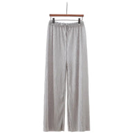 Striped pants hanging on a hanger against a white background