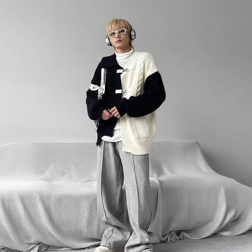 Person in layered streetwear with sweater, headphones, and silver bag