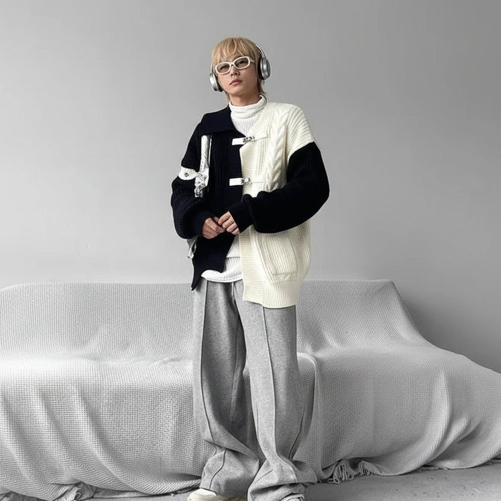 Person in layered streetwear with sweater, headphones, and silver bag