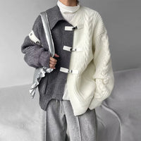 Fashion model wearing color-blocked oversized sweater with silver bag