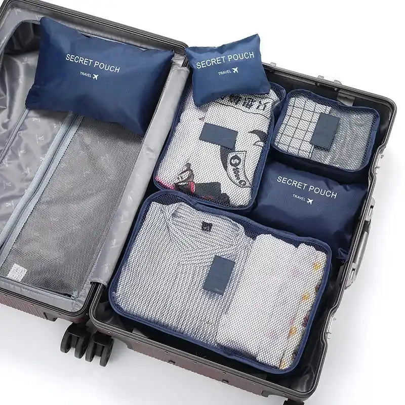 Navy blue 6PC Travel Storage Set in suitcase with mesh-top organizers for efficient packing of clothes and accessories.