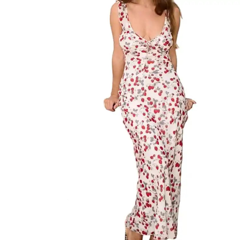 White Cryptographic floral print plunge maxi dress with red accents, styled for casual summer dining or vacation wear.